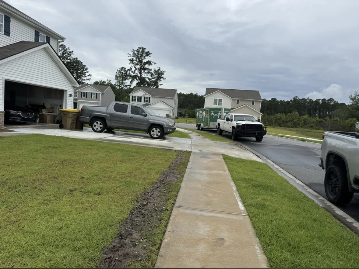 Freshly pressure washed concrete sidewalk and driveway on a residential street