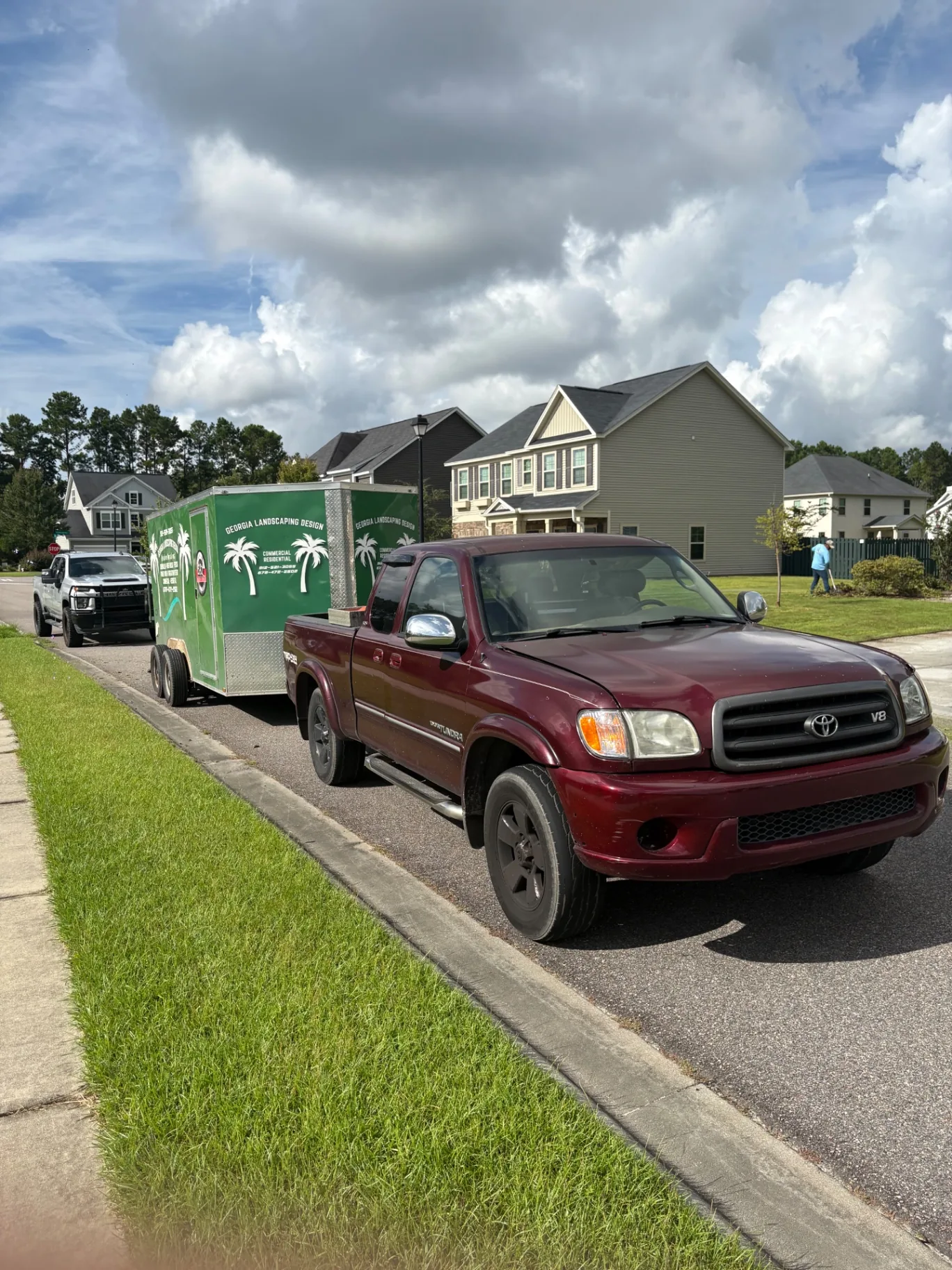 Georgia Landscaping Design truck and enclosed equipment trailer on a commercial route